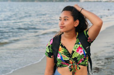 Sahilde duran düşünceli kadın.