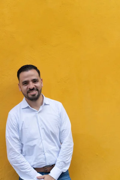 Giovane Uomo Piedi Davanti Muro Giallo Sta Guardando Telecamera Sorridendo — Foto Stock