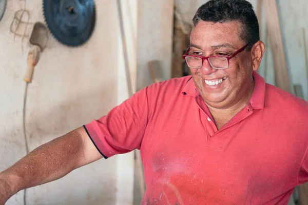 Smiling Carpenter At His Workshop