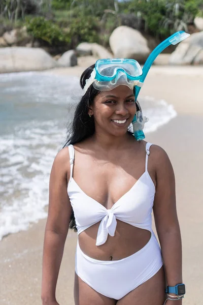 African Woman swimmer wearing goggles and snorkel on a sunny summer day