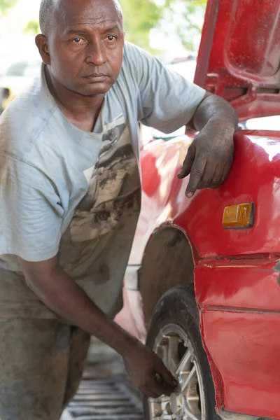 Portrait of African male car mechanic in his workshop