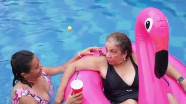 Mature Women Relaxing By The Pool Outdoors