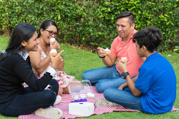 Latin Family spending a day outdoors, having a picnic