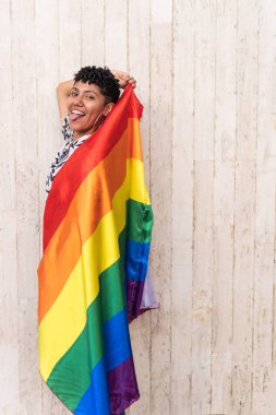 Latin woman dancing with pride flag