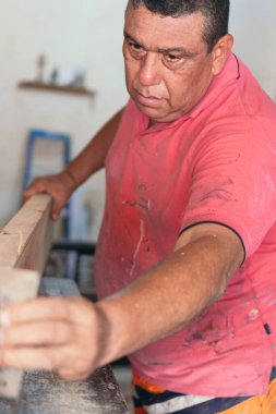 Bir marangoz dükkanında çalışan olgun bir marangoz.