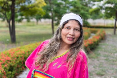 Portrait of an indigenous woman looking at the camera smiling and happy.