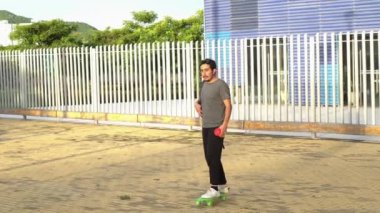 man leaving the university on a skateboard
