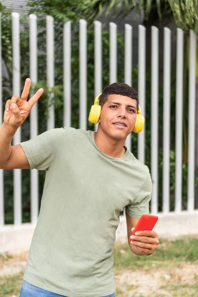 Young Man His Laughing Wearing Headphones Showing Victory Sign — Foto Stock