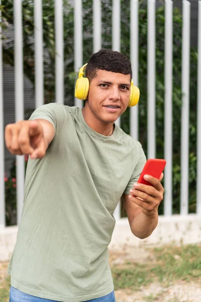 Latin Man Headphones Using Mobile Phone City Street — стокове фото