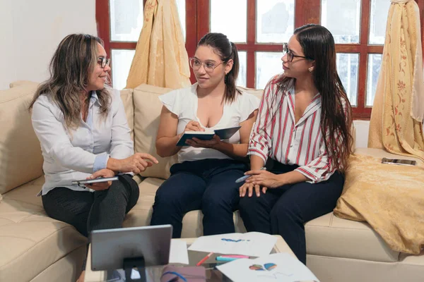 Olgun bir kadın bayan meslektaşlarıyla yeni bir projeyi tartışıyor..