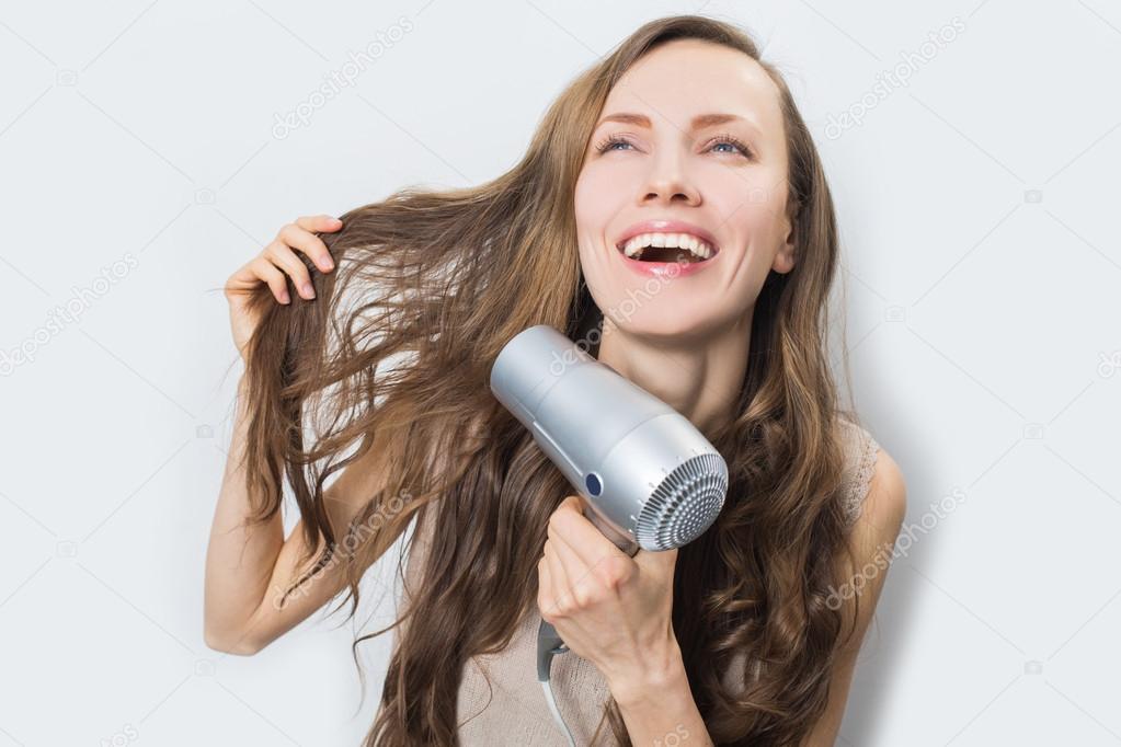 Happy woman with blow dryer