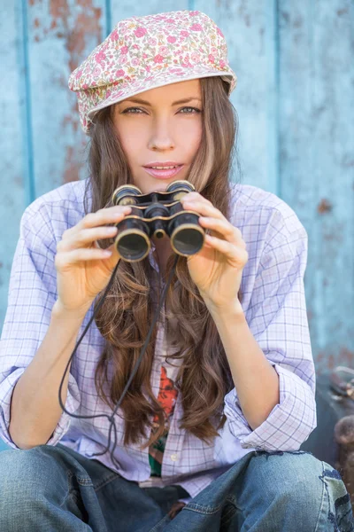 Young woman looking in binoculars — Stock Photo, Image