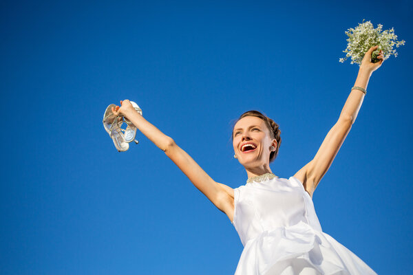 Happy bride over blue sky