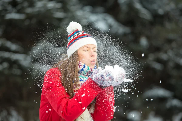 Christmas girl. Winter woman blowing snow Stock Photo