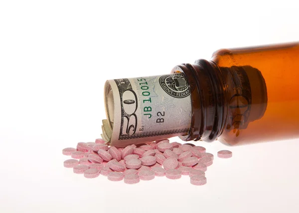 Open bottle of pills with Dollar — Stock Photo, Image