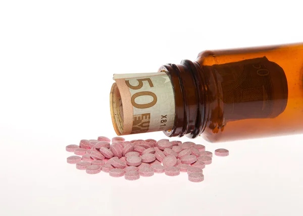 Open bottle of pills with Euro — Stock Photo, Image