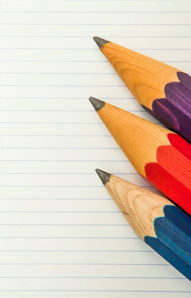 Three Pencils and lined paper — Stock Photo, Image
