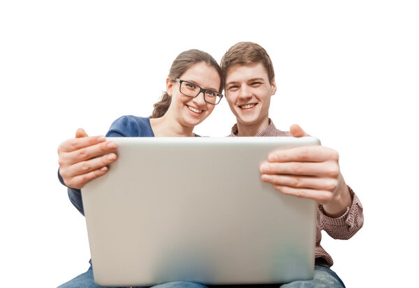 Couple in love holding laptop and smiling at camera