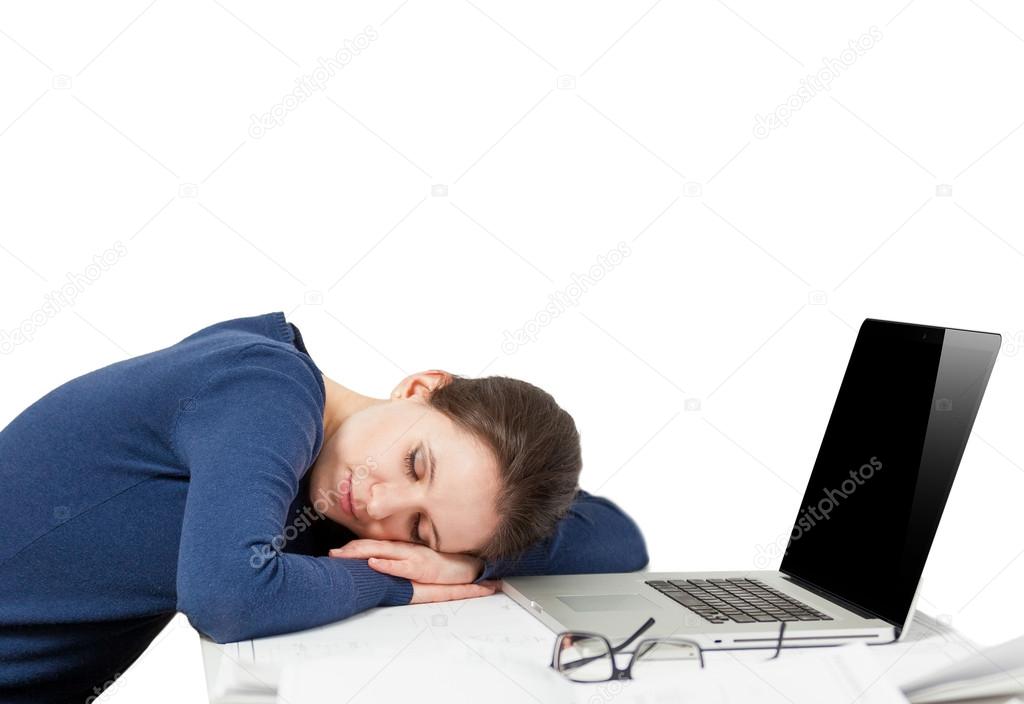 Portrait of tired young woman sleeping on working place