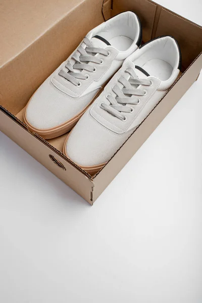 New white shoes in box. Casual man shoes on white background