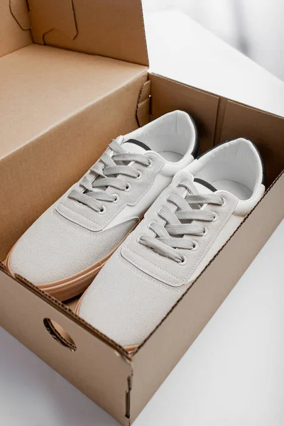 New white shoes in box. Casual man shoes on white background