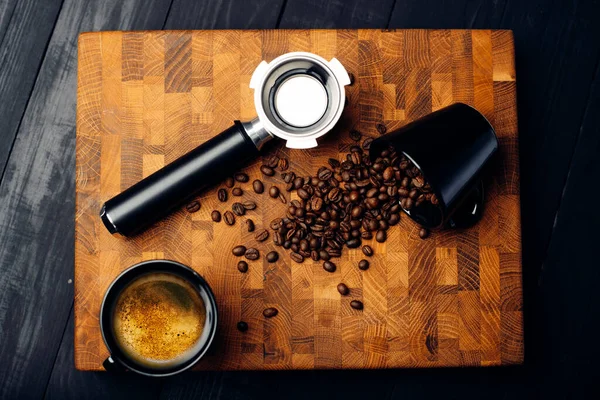 Scattered coffee beans on wooden board. Coffee background