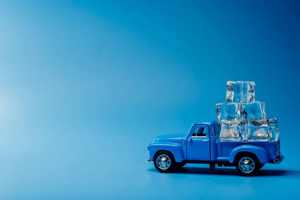 Toy blue car with ice. Minimalism Ice Machine.