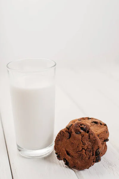 Glass of milk and chocolate biscuits for breakfast.