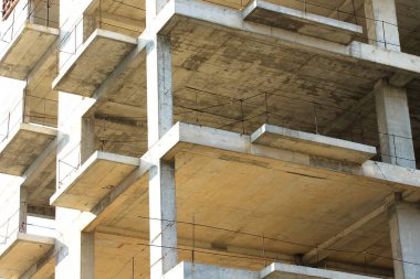 Yüksek katlı yeni bir apartmanın beton inşaatı. Tamamlanmamış binaların dış görünüşü. Yerleşik kompleks dış görünüş. Emlak yatırımı. Levhalar, penceresiz duvarlar. 