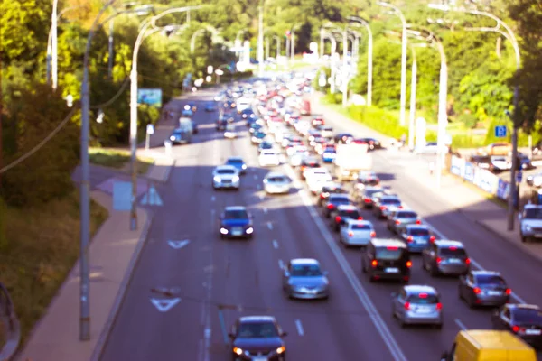 The movement of cars with lights on a road, highway. Blurred photo with the image of cars of different brands of top view. Speed, vehicle traffic at sunny spring or summer day. Big city life, energy. — Stock Photo, Image