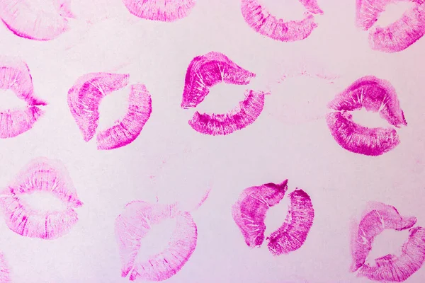 Pink female lip prints on white background. Kisses, smacks, lipstick prints.