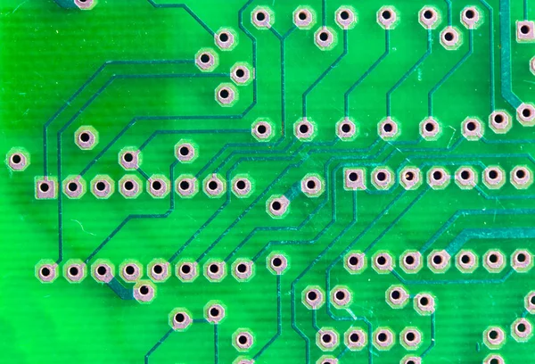 Printed green circuit board close-up. Electronic computer hardware technology macro photo. A digital motherboard chip. Microprocessor, transistors, semiconductor made from silicon. Technical science. — Stock Photo, Image