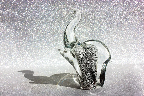 Elephant Murano glass figure on silver shining background. Animal Talisman. — Stock Photo, Image