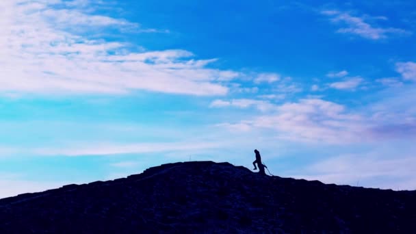 Силуэты Двух Человек Взбирающихся Вершину Холма Фоне Голубого Неба Отец — стоковое видео