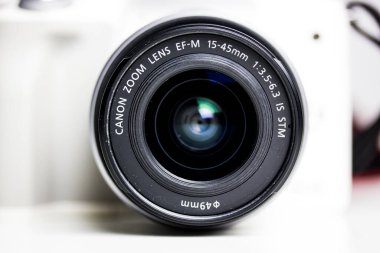 Kyiv, Ukrayna. 7 Ocak 2022. Beyaz dijital aynasız 4K kamera Canon EOS M50 ve beyaz arka planda siyah lens. EF-M 15-45 mm mercekli aynasız kamera kiti. Fotoğrafçı teknikleri.