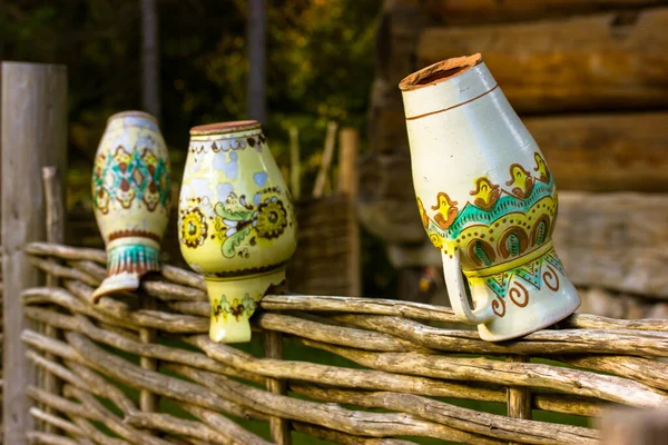 Clay Jugs Ethnic Pitchers Hanging Wicker Wattle Fence Wooden House — Stock Photo, Image