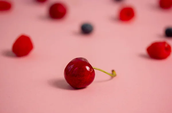 Ripe Berries Scattered Pink Table Background Bright Red Cherry Focus —  Fotos de Stock