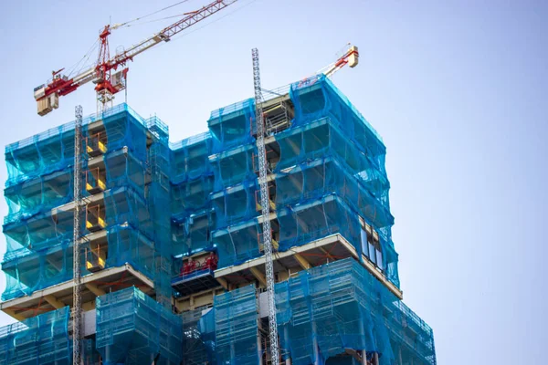 Two Multistory Buildings Facade Covered Protective Construction Mesh Blue Sky — Fotografia de Stock