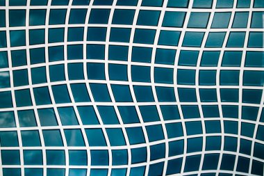 Square bathroom tile with winding straight lines irregular shapes. Blue small tiles for bath, floor, wall. Architectural texture details. Surrealistic pool tile abstract background. Mosaic wallpaper.