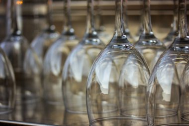 A lot of empty wine glasses. Row of clean glass transparent glasses are on a table on banquet in a bar, cafe, restaurant Crystal kitchenware for drinks - wine, champagne, alcohol drink selective focus