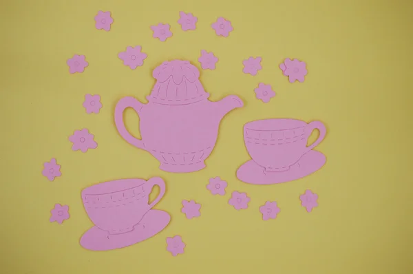 Paper cut out of pink teapot with cups and saucers — Stock Photo, Image