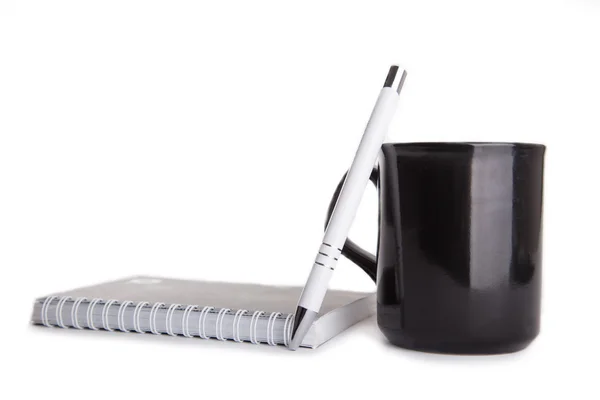 Beyaz kalem, defter ve koyu bir kahve Kupası