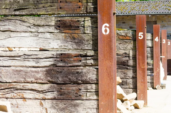 Rusted steel beams with white numbers — Stock Photo, Image