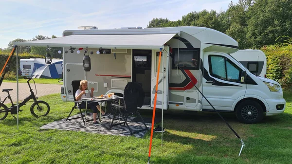 A new mobile home with awning and table and chairs