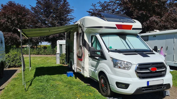 Campers parked on a Camer Van pitch. Concept camper van leisure and fun