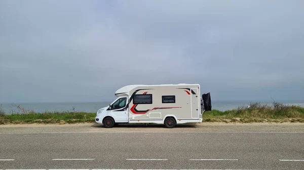 View over the sea from the dune over North Sea and canal in Ouddorp, Zeeland province, The Netherlands. Outdoor scene of coast in Europe nature.