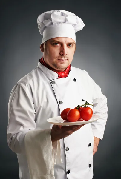 Cook with tomatoes — Stock Photo, Image