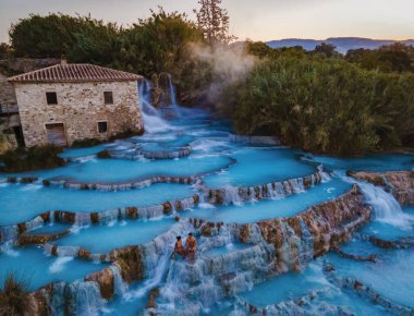 Toscane Italy, natural spa with waterfalls and hot springs at Saturnia thermal baths, Grosseto, Tuscany, Italy aerial view on the Natural thermal waterfalls at Saturnia clipart