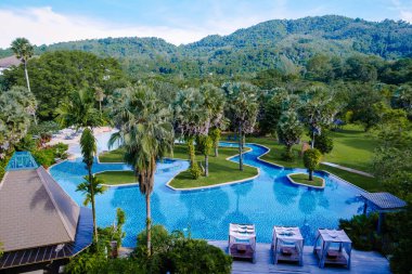 Lüks otel yüzme havuzu, güzel tropik plaj ve deniz şemsiyeli ve sandalyeli otel havuzunda seyahat ve tatil için yüzme havuzu.