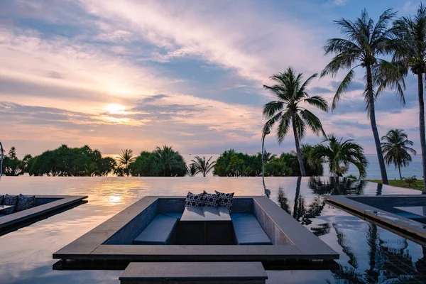 watching sunset in infinity pool on a luxury vacation in Thailand, watching sunset on the edge of a pool in Thailand